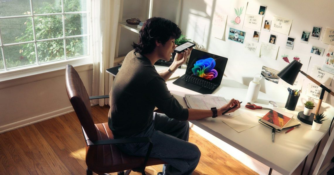 Person working at a desk with a laptop and books.